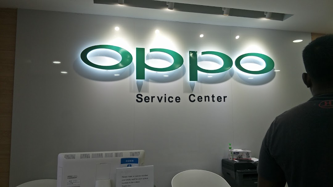 An interior view of the OPPO Service Center, featuring the illuminated OPPO logo and a service counter.