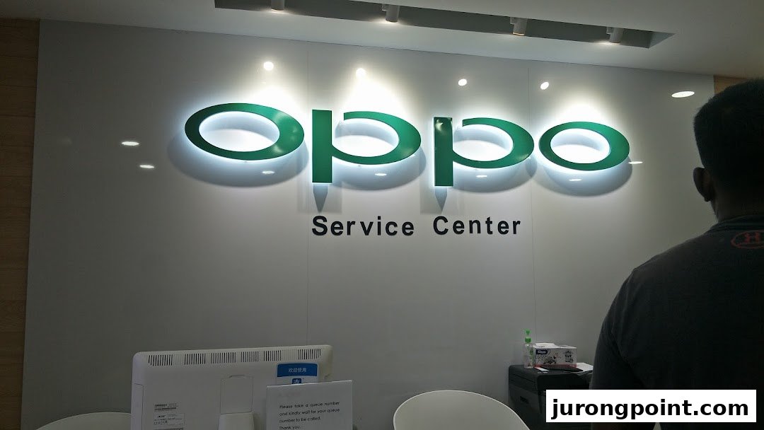 An interior view of the OPPO Service Center, featuring the illuminated OPPO logo and a service counter.