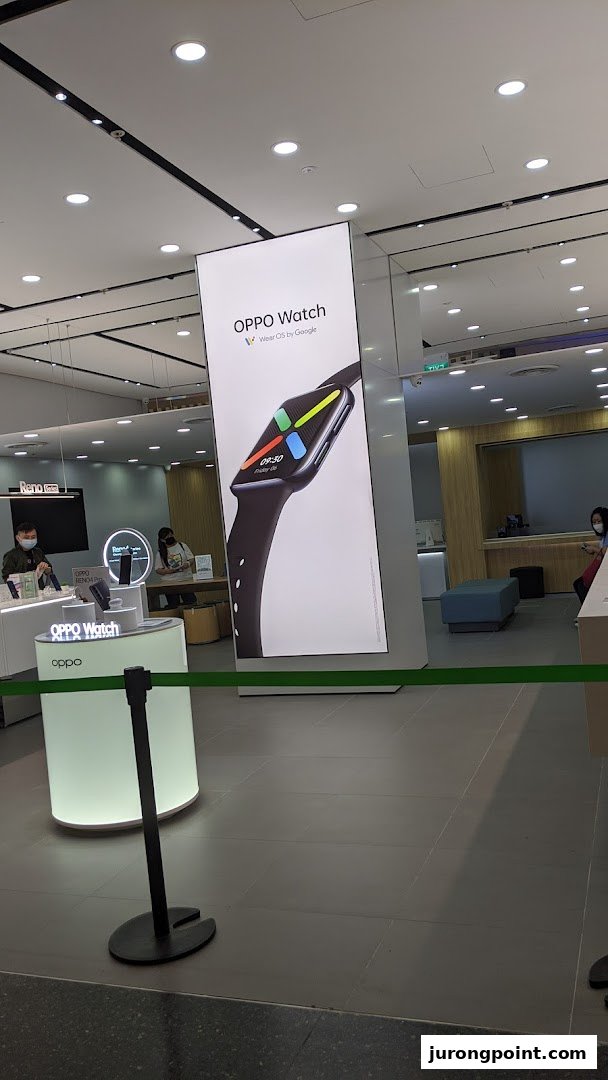 Interior view of an OPPO Concept Store featuring a large OPPO Watch display and product counters.