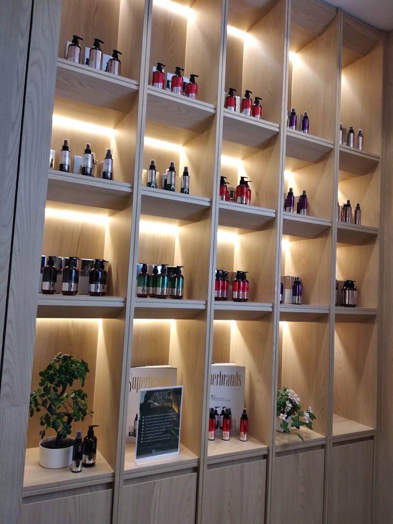 An interior view of Oriental Hair Solutions, showcasing various hair care products on illuminated wooden shelves.