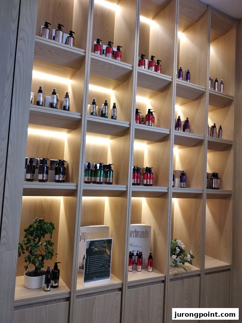 An interior view of Oriental Hair Solutions, showcasing various hair care products on illuminated wooden shelves.