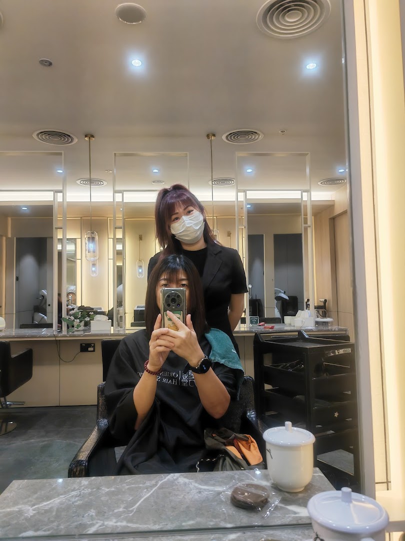 Customer and stylist captured in a mirror selfie, showcasing a professional salon experience.