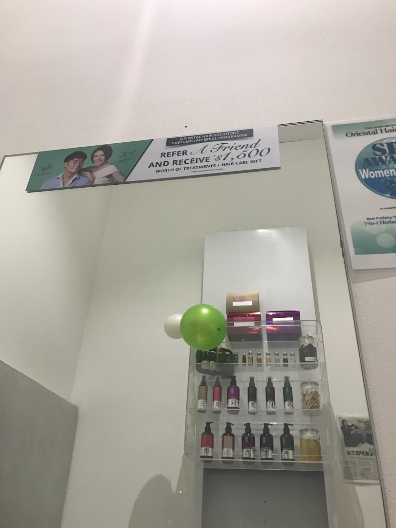 An interior view of Oriental Hair Solutions showcasing hair care products, a referral program banner, and awards.