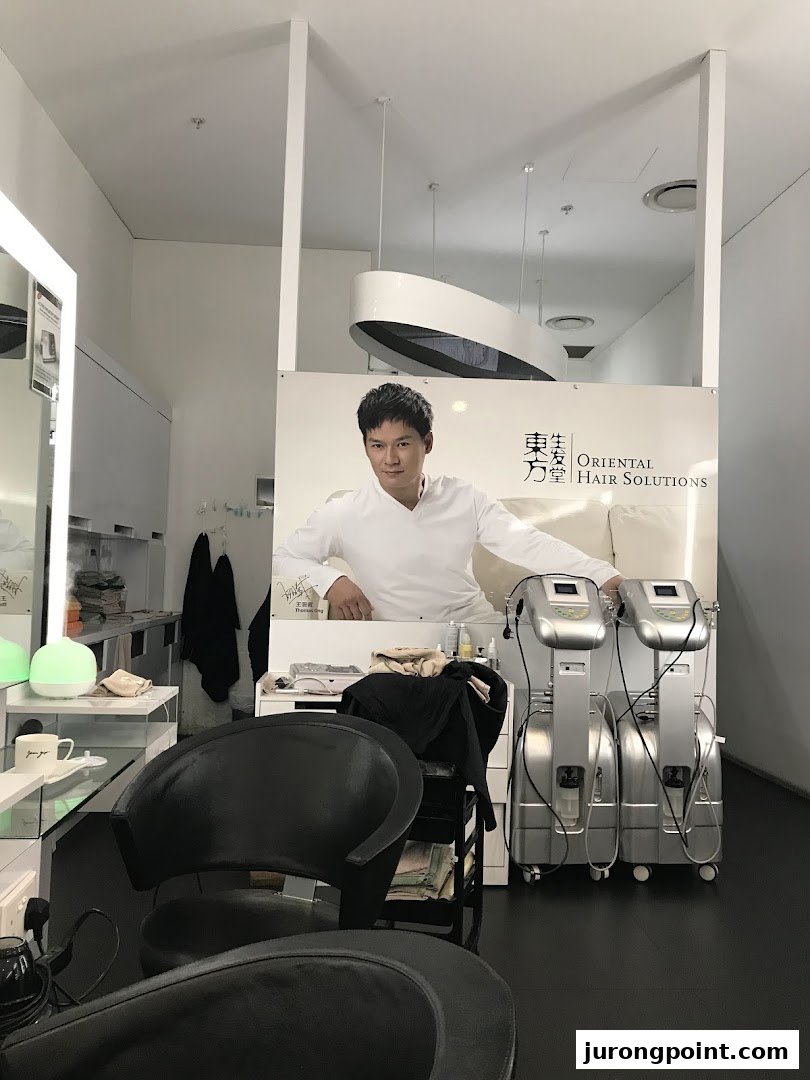 Interior view of Oriental Hair Solutions, featuring a large promotional banner and hair treatment equipment.