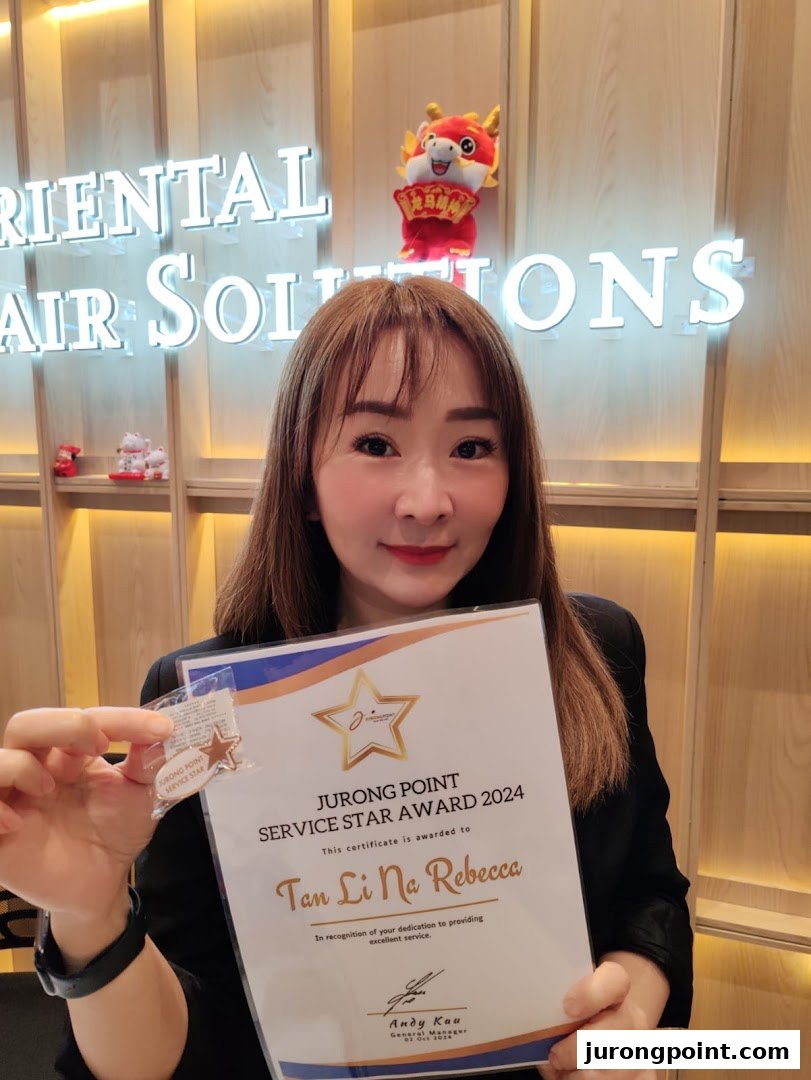 A staff member from Oriental Hair Solutions proudly displays a Jurong Point Service Star Award 2024.