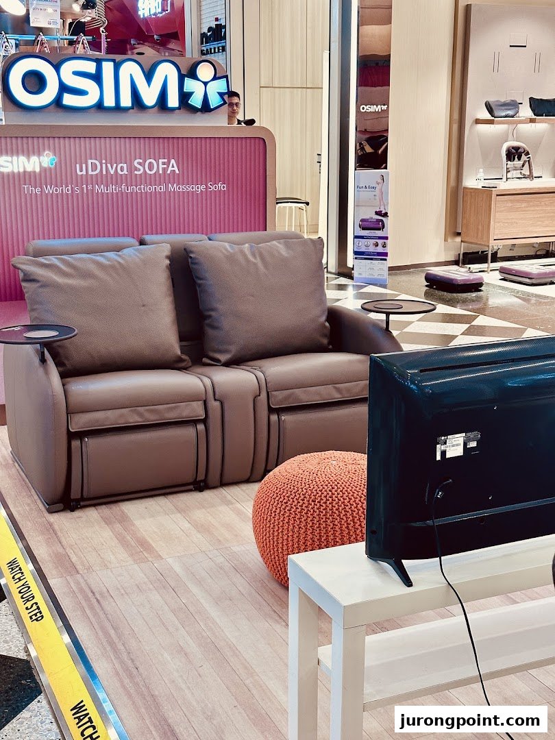 An OSIM store display featuring the uDiva SOFA, a multi-functional massage sofa, with other wellness products.