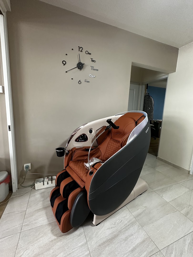 A luxurious brown and black OSIM massage chair displayed in a modern setting.