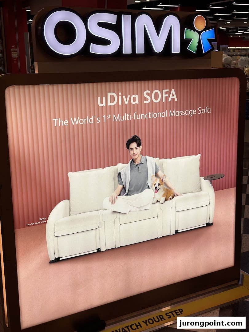 An OSIM display board showcases the uDiva SOFA, featuring a model and a cute dog.