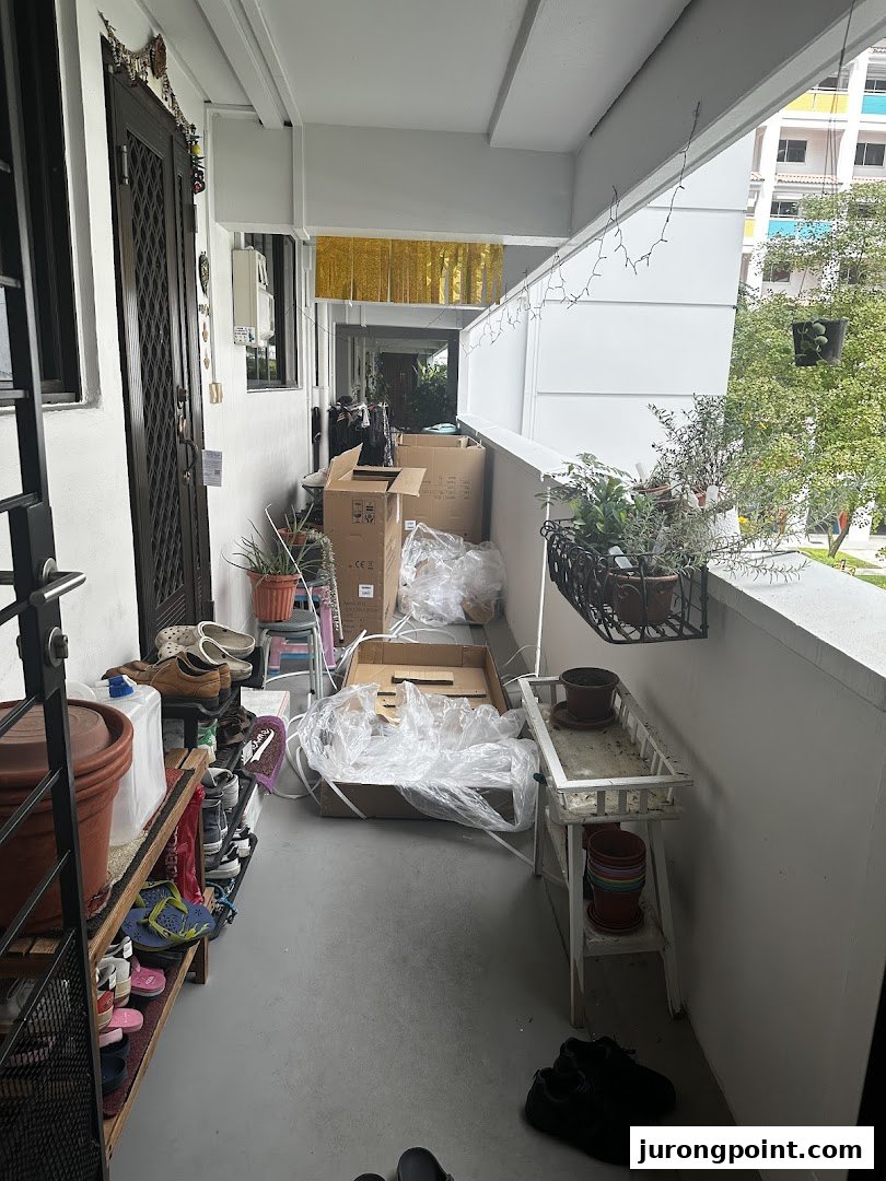 A cluttered back-of-house area with unpacked product boxes, personal items, and plants.