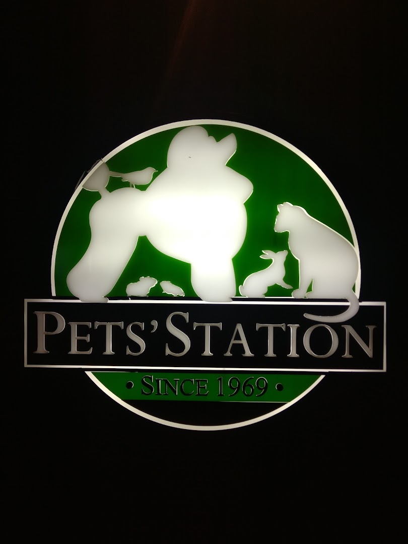 An illuminated Pets' Station logo featuring various pet silhouettes on a green background.