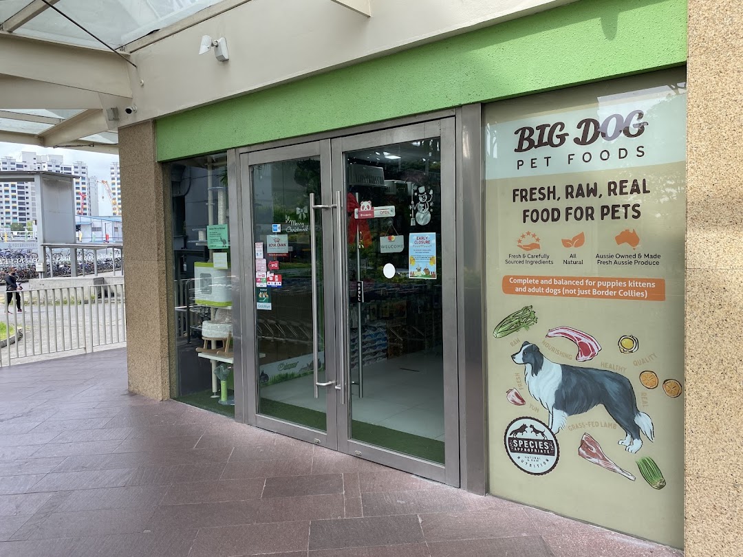 The exterior of Pets Station, a pet supply store, featuring a large window display for pet food.