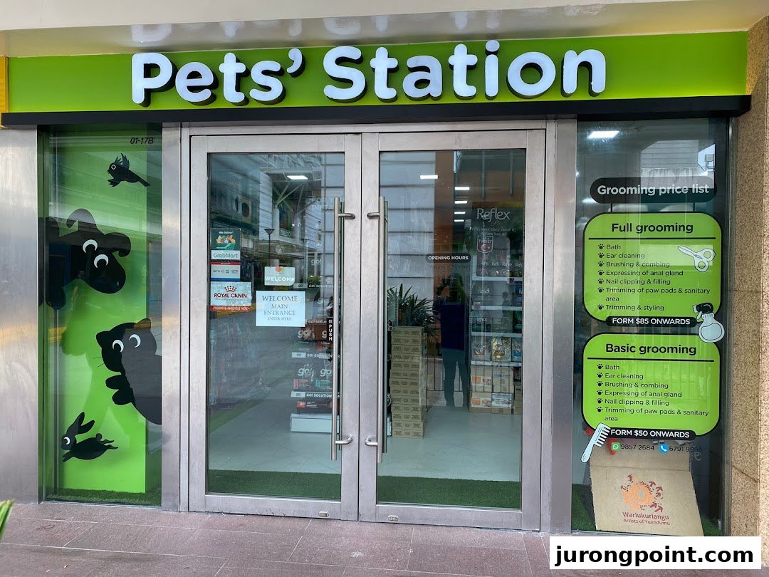 The vibrant green storefront of Pets' Station, a pet supply and grooming shop.