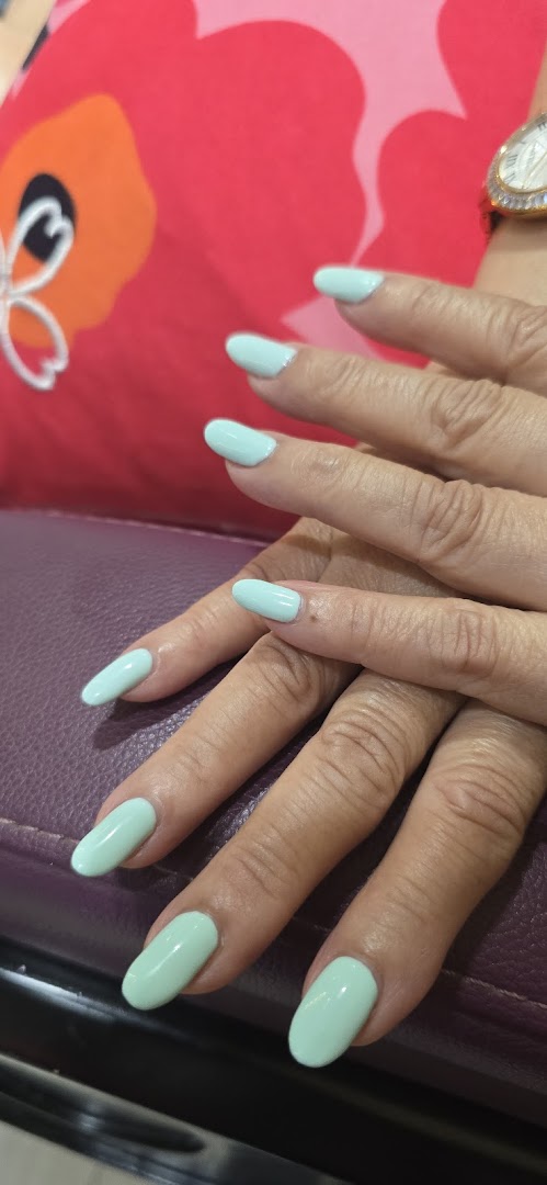 Close-up of hands with freshly manicured, long, light blue nails, showcasing a nail service.