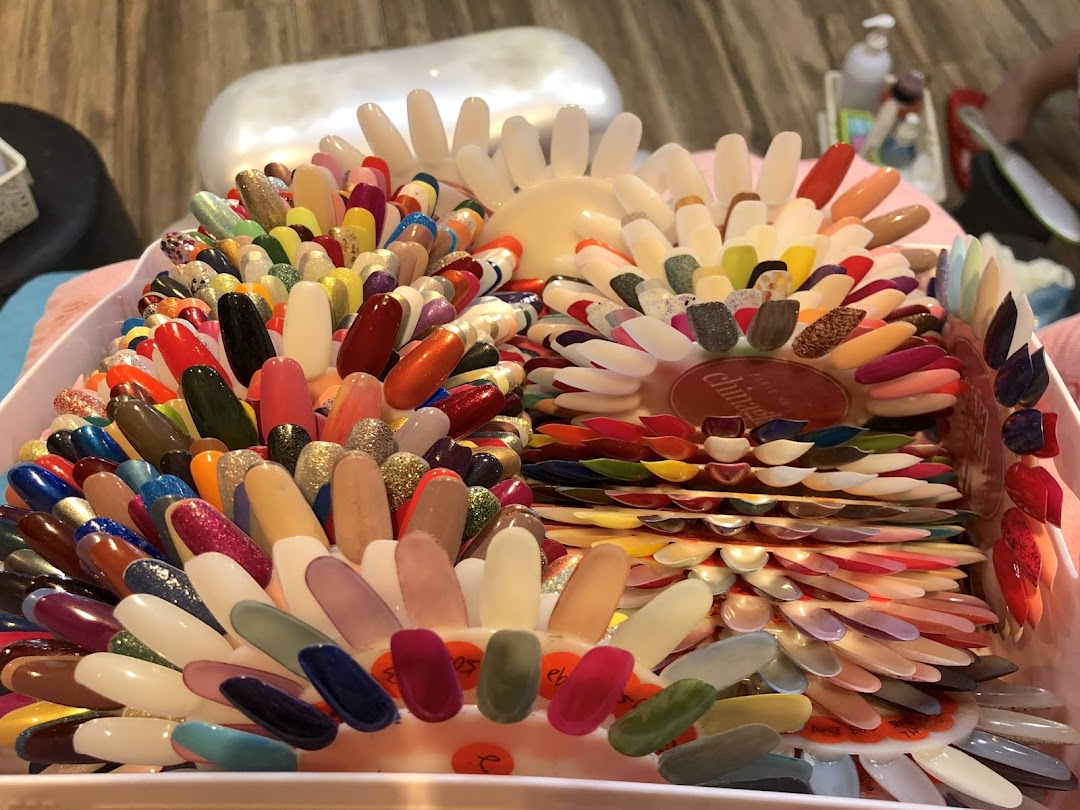 A vibrant display of numerous nail polish color samples on swatches at Pixie Nail Spa.