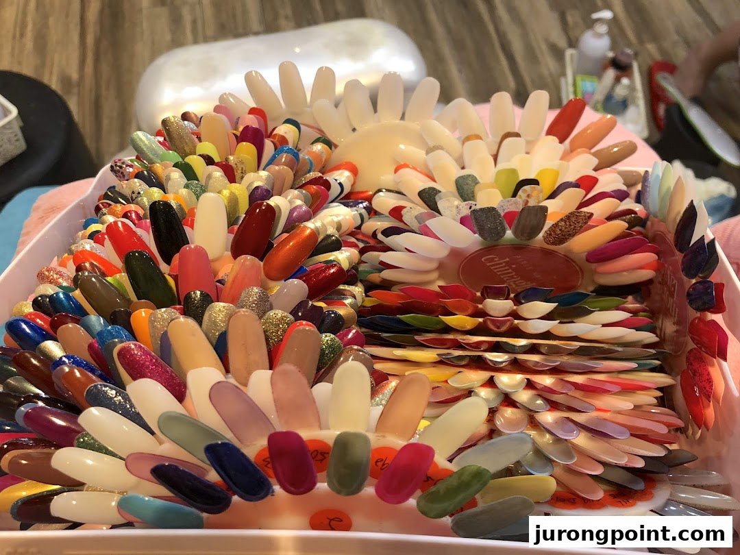 A vibrant display of numerous nail polish color samples on swatches at Pixie Nail Spa.