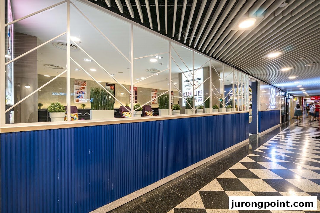 The vibrant blue and white facade of Pixie Nail Spa, seen from the mall corridor, inviting relaxation.
