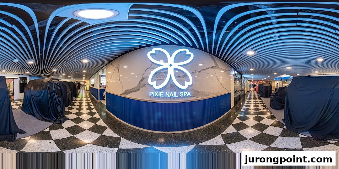 The illuminated entrance of Pixie Nail Spa, featuring a distinctive logo and modern blue and white decor.