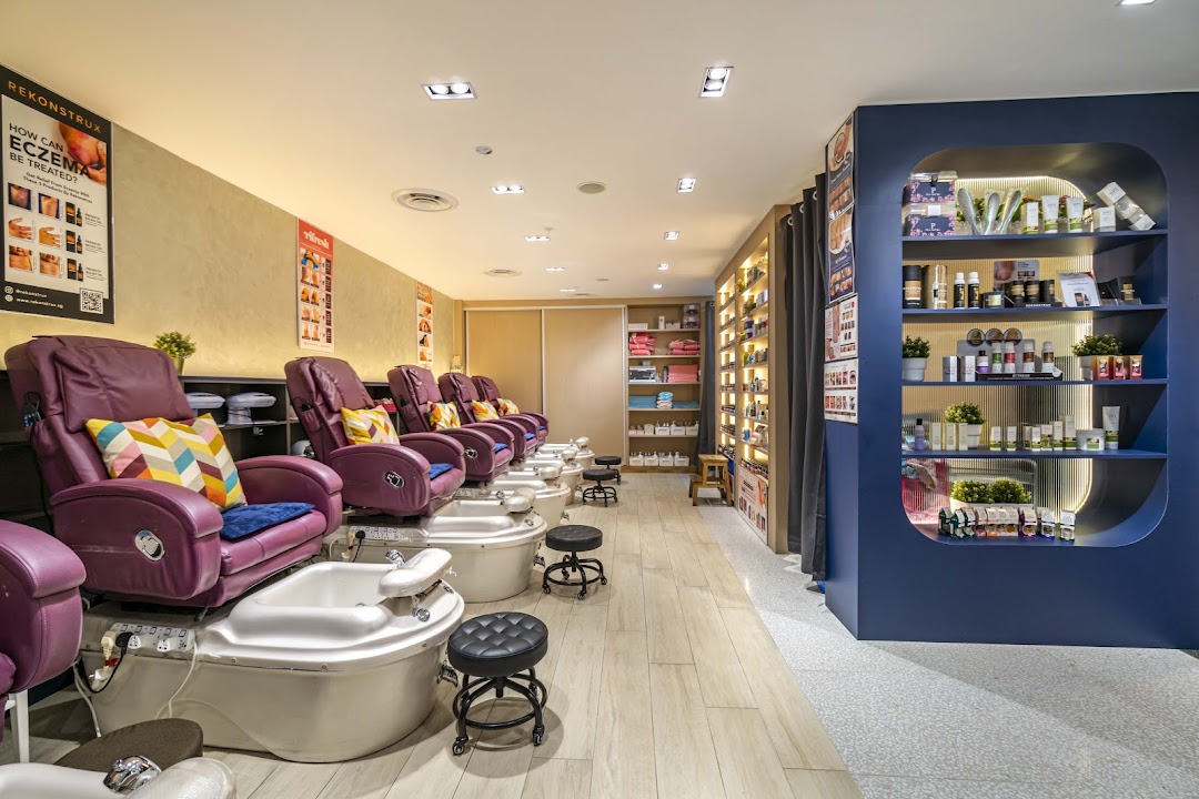 Interior view of Pixie Nail Spa featuring comfortable pedicure chairs and product displays.