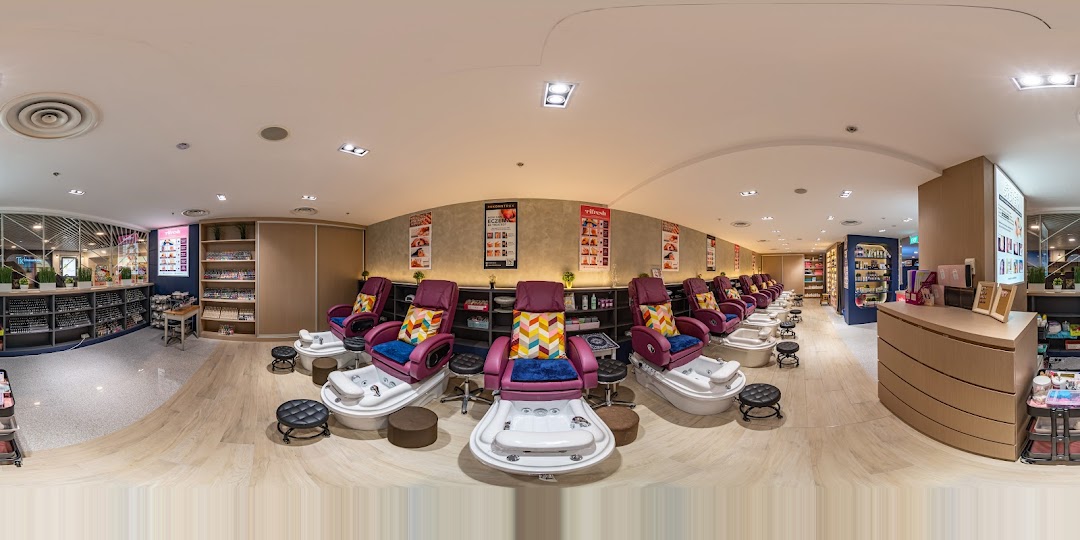 A panoramic view of Pixie Nail Spa's interior, featuring multiple pedicure stations and extensive nail polish displays.