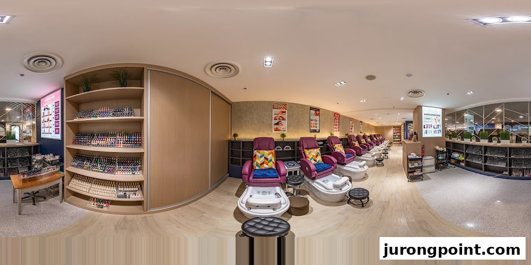 A panoramic view of Pixie Nail Spa's interior, featuring comfortable pedicure stations and extensive nail polish displays.