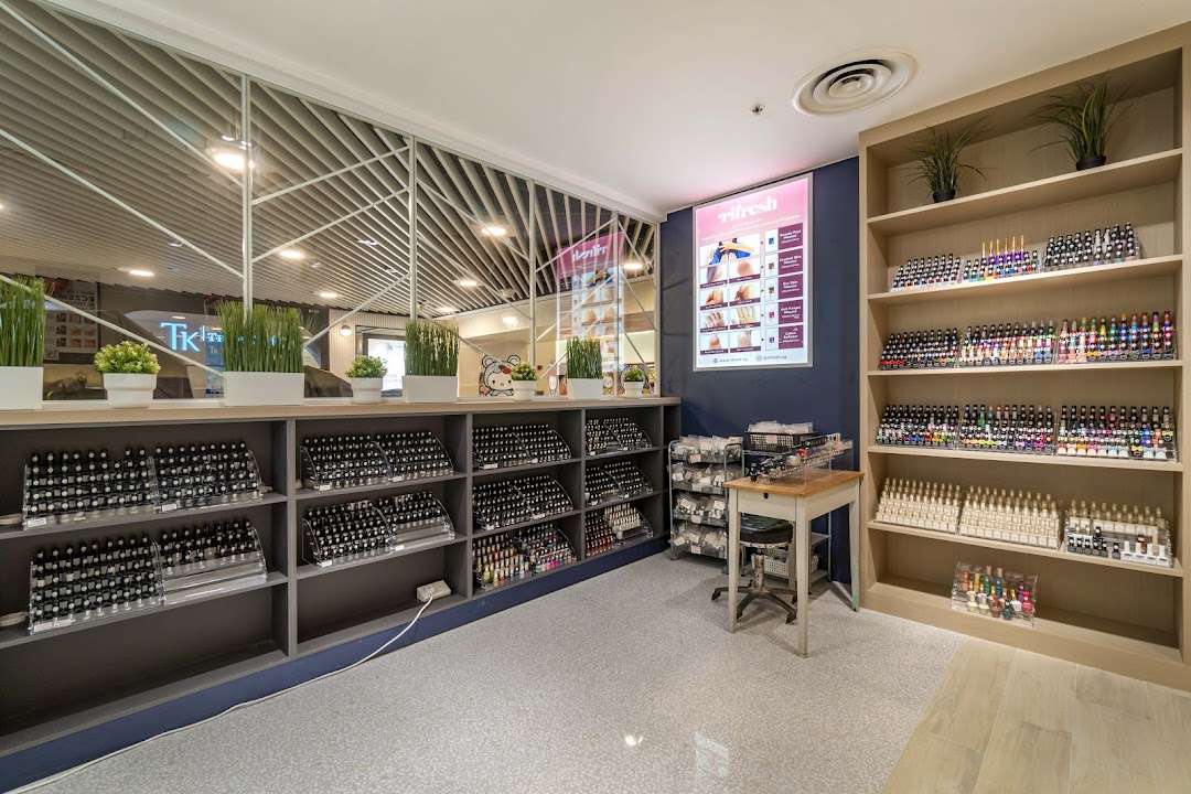 Interior view of Pixie Nail Spa showcasing extensive nail polish collections and a clean, inviting space.