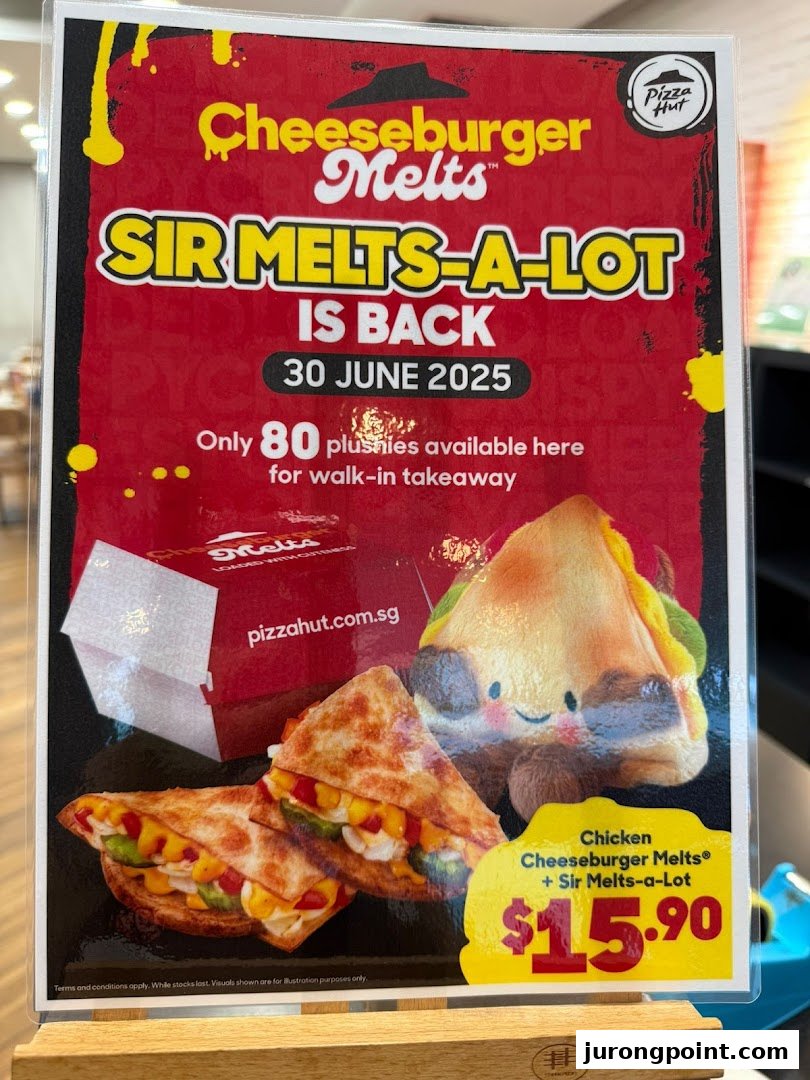 A Pizza Hut promotional standee advertising Cheeseburger Melts and a Sir Melts-a-Lot plushie combo.