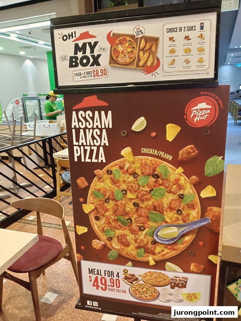 Promotional standees for Pizza Hut featuring the Assam Laksa Pizza and a 'My Box' deal.