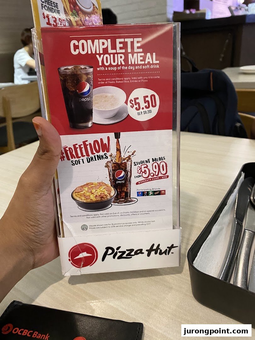 A Pizza Hut table tent displaying promotional meal deals and student offers.