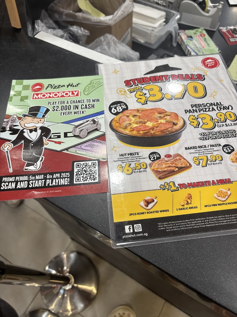 Two Pizza Hut promotional flyers showcasing student deals, menu items, and a Monopoly game promotion.