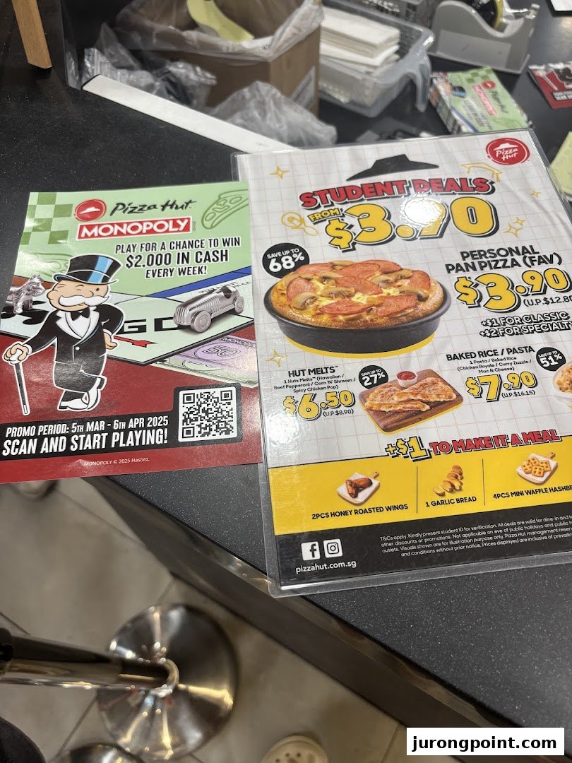 Two Pizza Hut promotional flyers showcasing student deals, menu items, and a Monopoly game promotion.