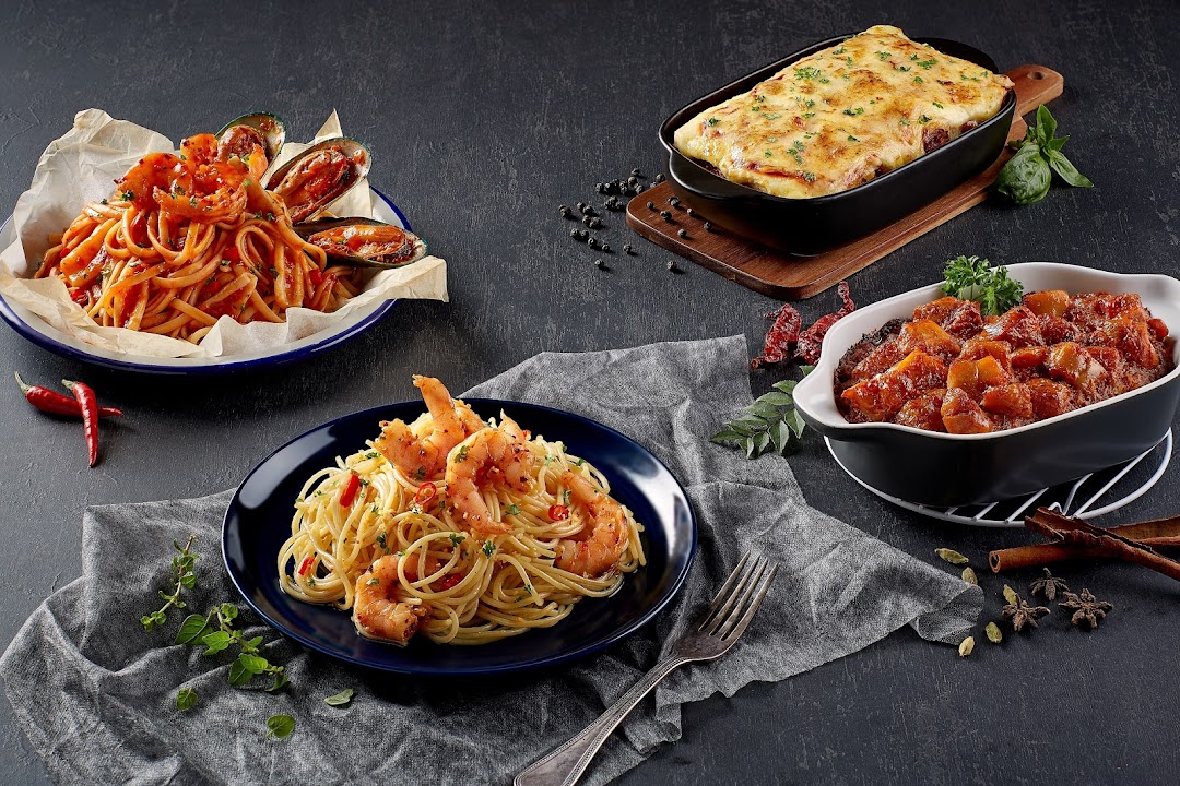 A vibrant spread of delicious pasta dishes, a baked casserole, and a savory stew.
