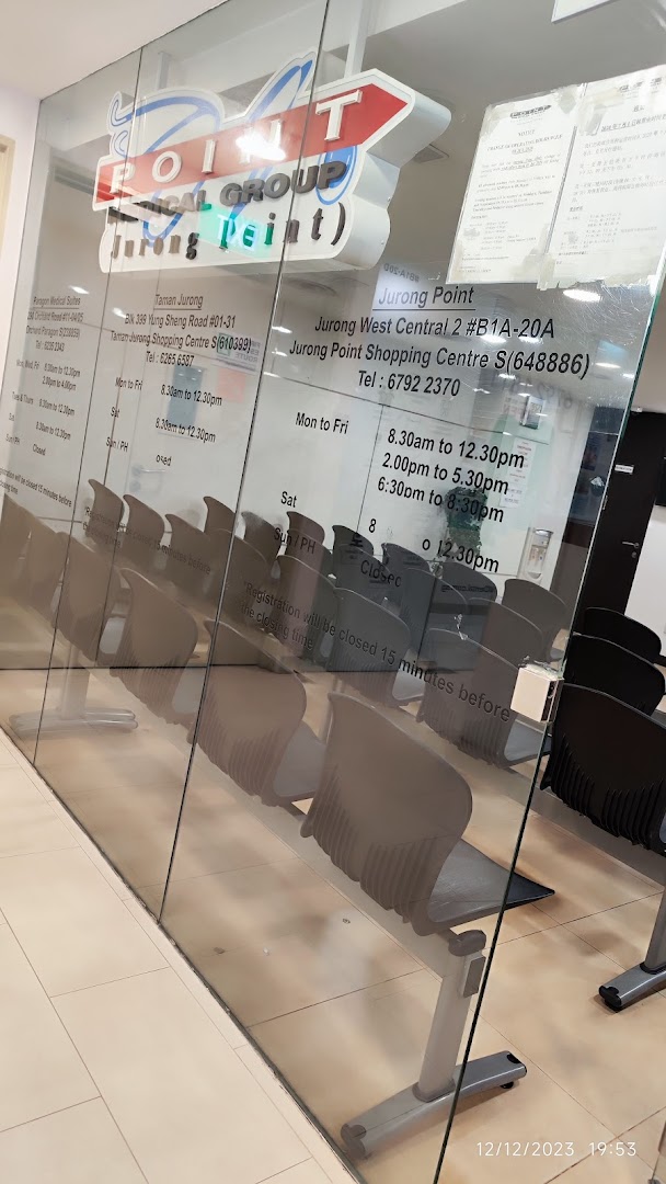 The glass facade of Point Medical Group Jurong Point, displaying its logo, operating hours, and a waiting area.