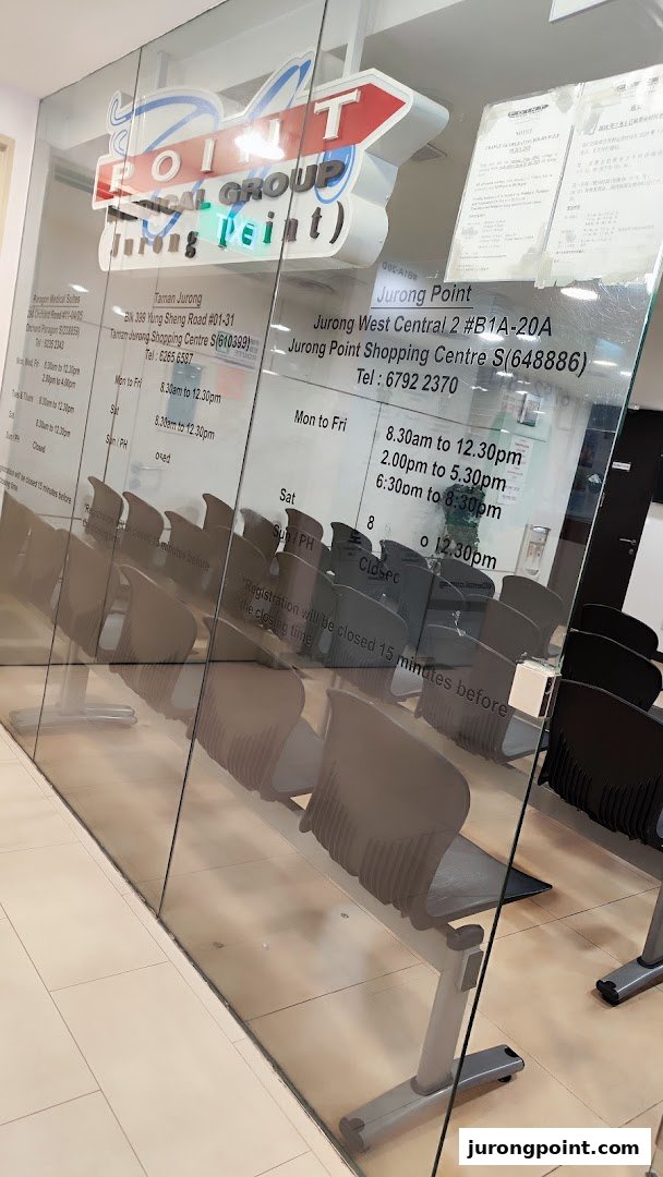 The glass facade of Point Medical Group Jurong Point, displaying its logo, operating hours, and a waiting area.