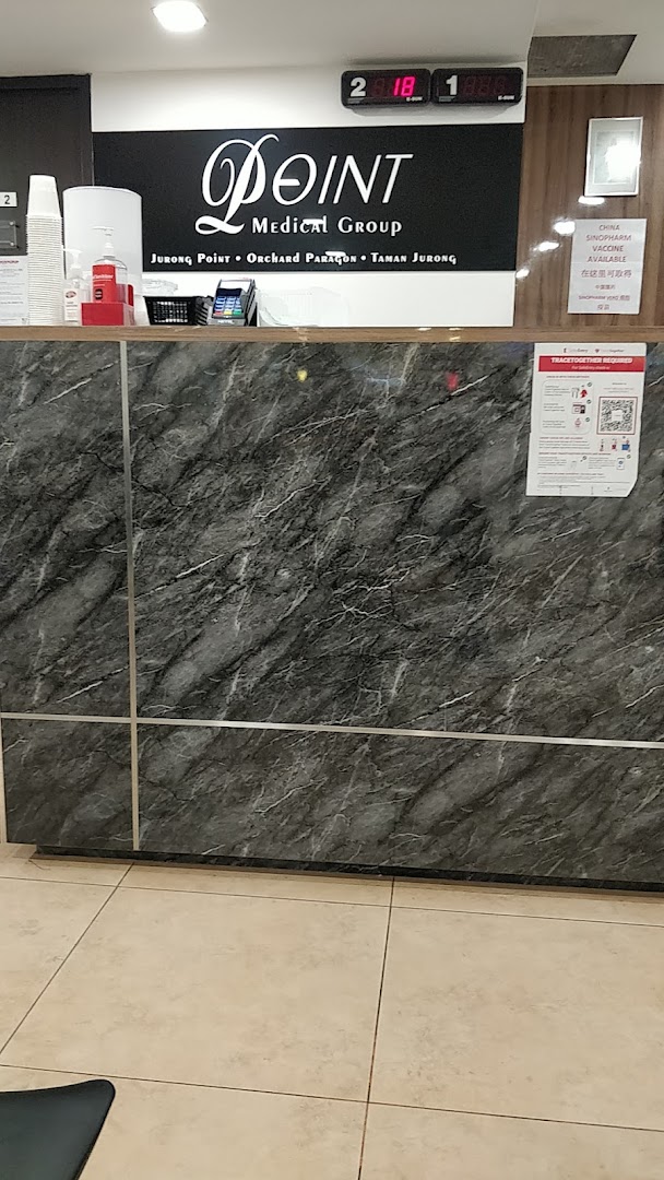 View of the reception desk at Point Medical Group, featuring branding and service information.