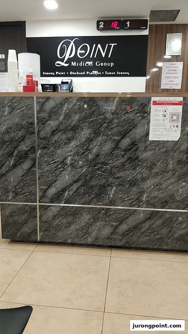View of the reception desk at Point Medical Group, featuring branding and service information.