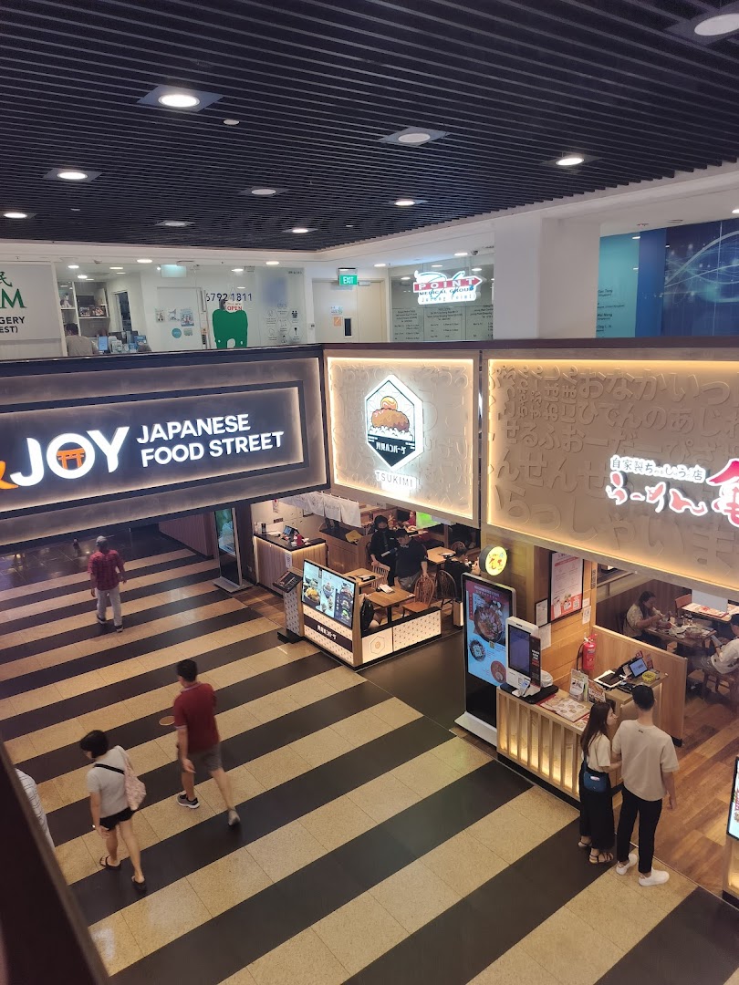 An overhead view of a bustling mall level featuring a medical clinic and Japanese food street.