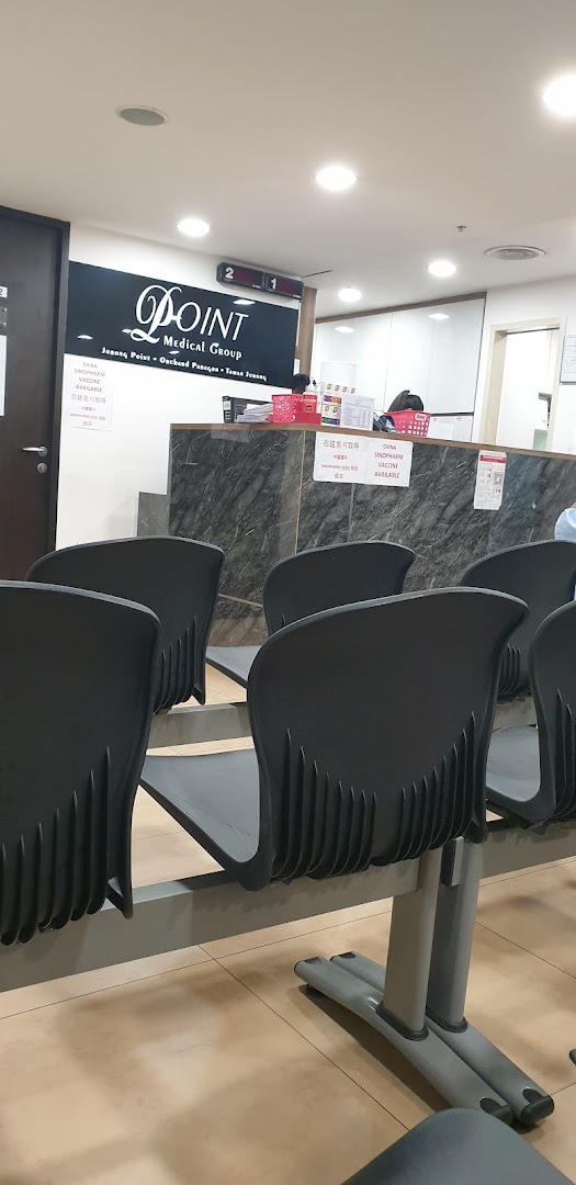 Interior view of Point Medical Group's waiting area with reception counter and seating.