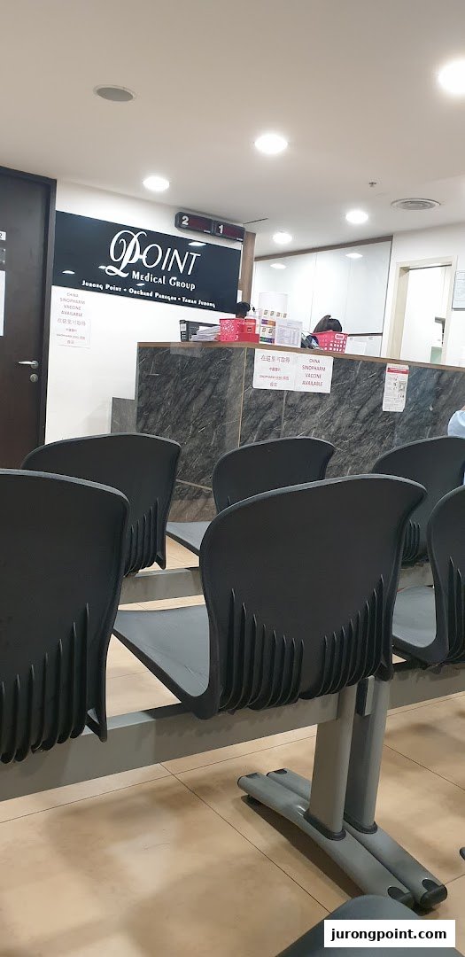 Interior view of Point Medical Group's waiting area with reception counter and seating.