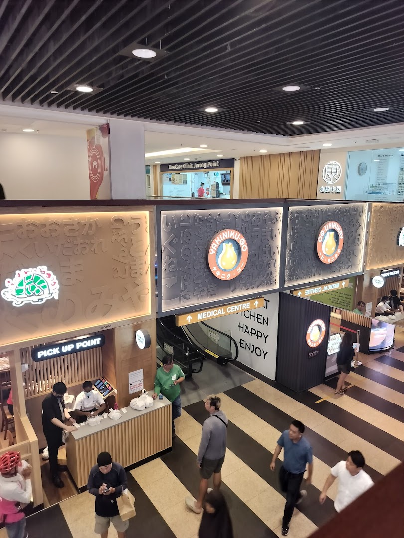 An overhead view of a bustling mall interior featuring various shops and a medical clinic.