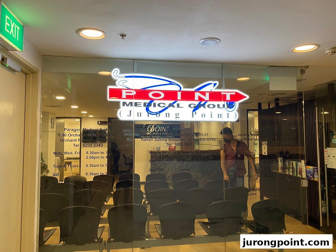 The glass entrance of Point Medical Group at Jurong Point, featuring its logo and interior waiting area.