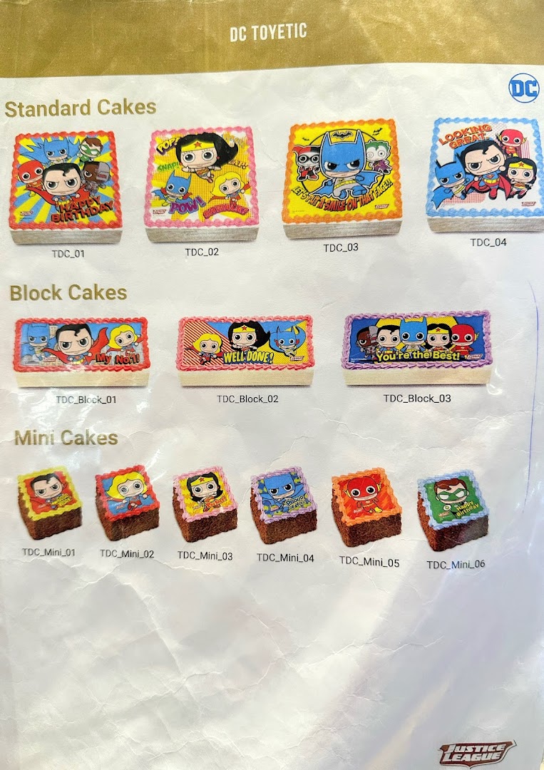 A catalog showcasing various DC Comics themed cakes, including standard, block, and mini sizes.