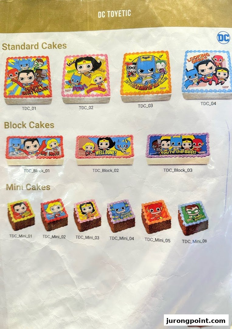A catalog showcasing various DC Comics themed cakes, including standard, block, and mini sizes.