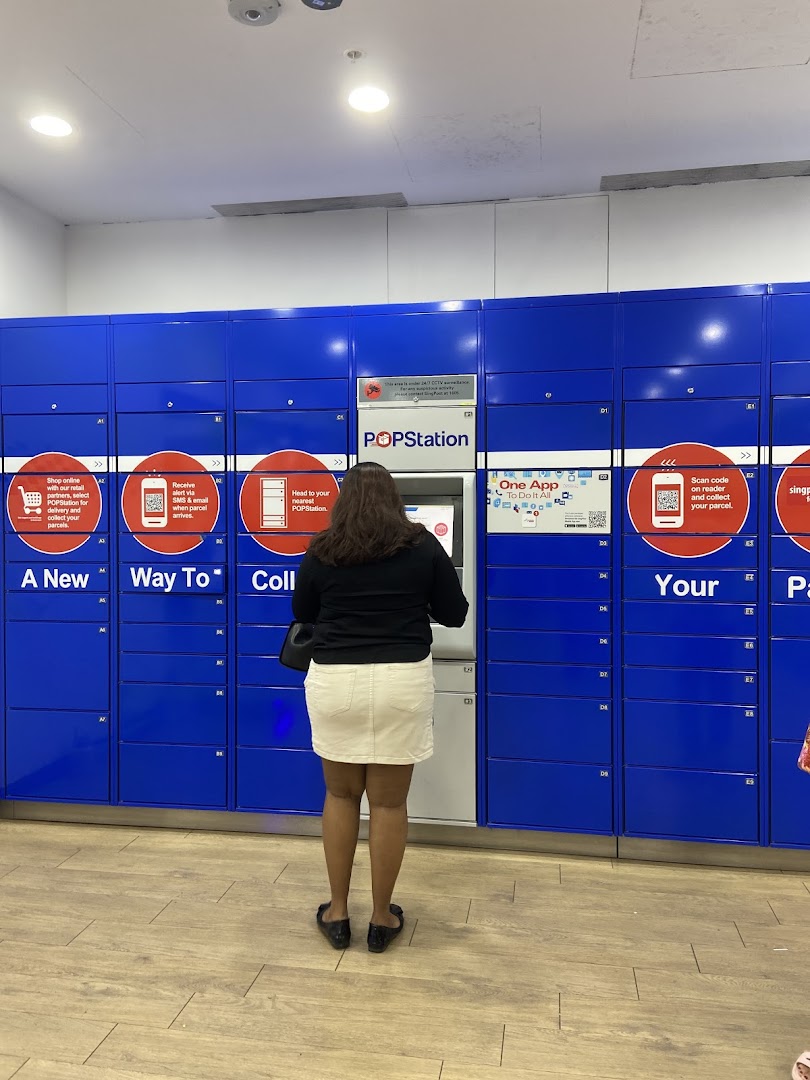 A person interacts with a POPStation parcel locker system, offering convenient collection and delivery services.