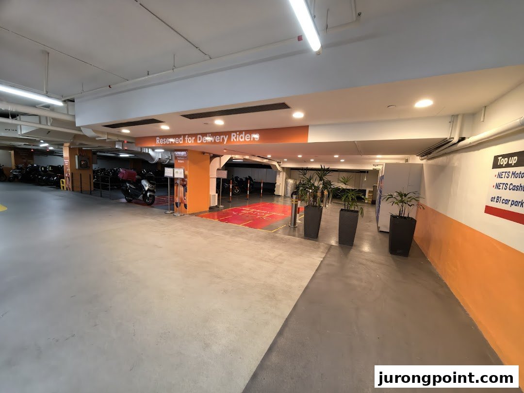 An underground car park area featuring POPStation lockers and a dedicated zone for delivery riders.
