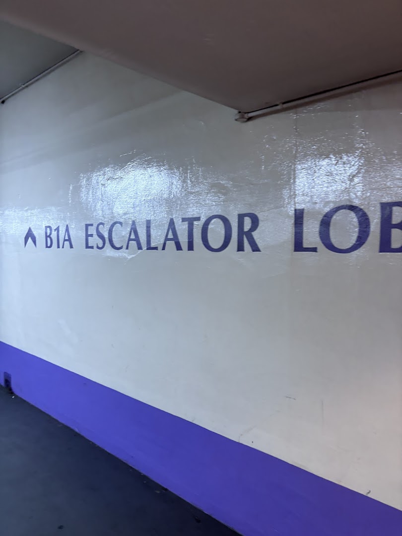 A wall sign indicating the B1A escalator lobby in a building or mall.