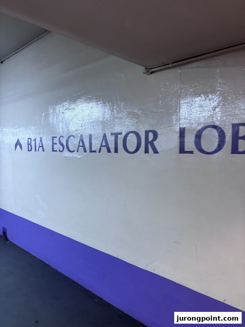 A wall sign indicating the B1A escalator lobby in a building or mall.