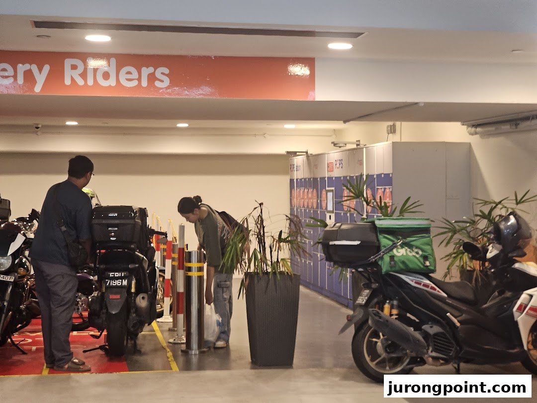 People and delivery riders accessing POPStation lockers in a mall's designated area.