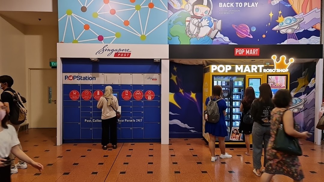 People interact with POPStation parcel lockers and POP MART Robo Shop vending machines in a mall.
