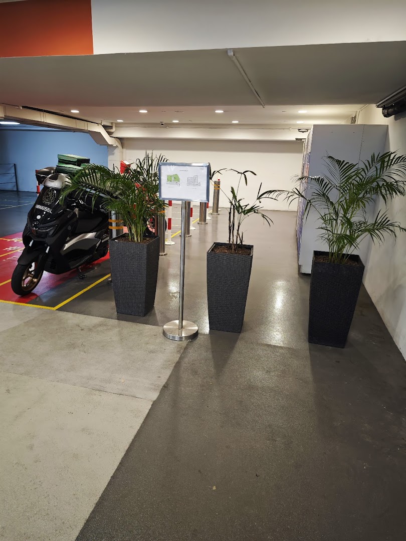 An indoor area featuring POPStation lockers, potted plants, and a parked scooter.