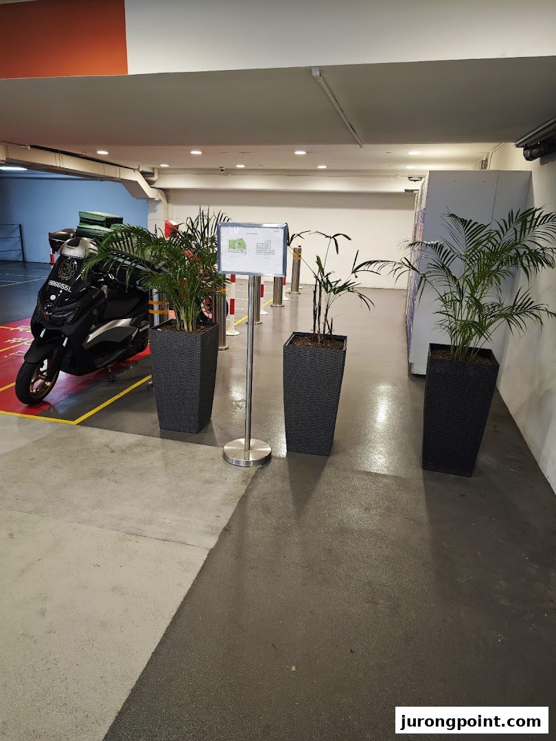 An indoor area featuring POPStation lockers, potted plants, and a parked scooter.